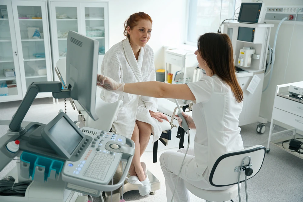 Doctor and female patient after transvaginal ultrasound examination